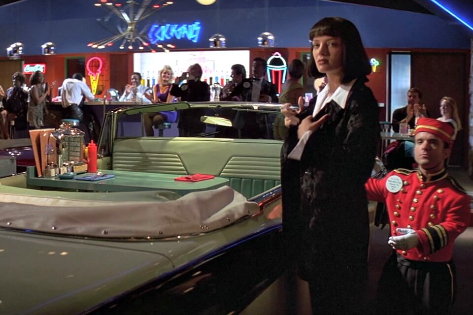 Quentin Tarantino's Pulp Fiction (1994) sets the stage for a dining booth fashioned out of a convertible 50's car